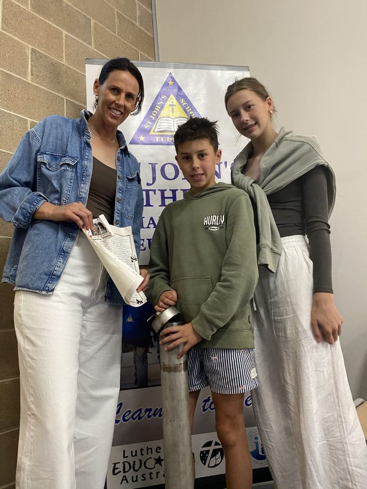 Jessica Geister (nee Handke), Sonny Geister and Leni Geister holding items from inside the time capsule.