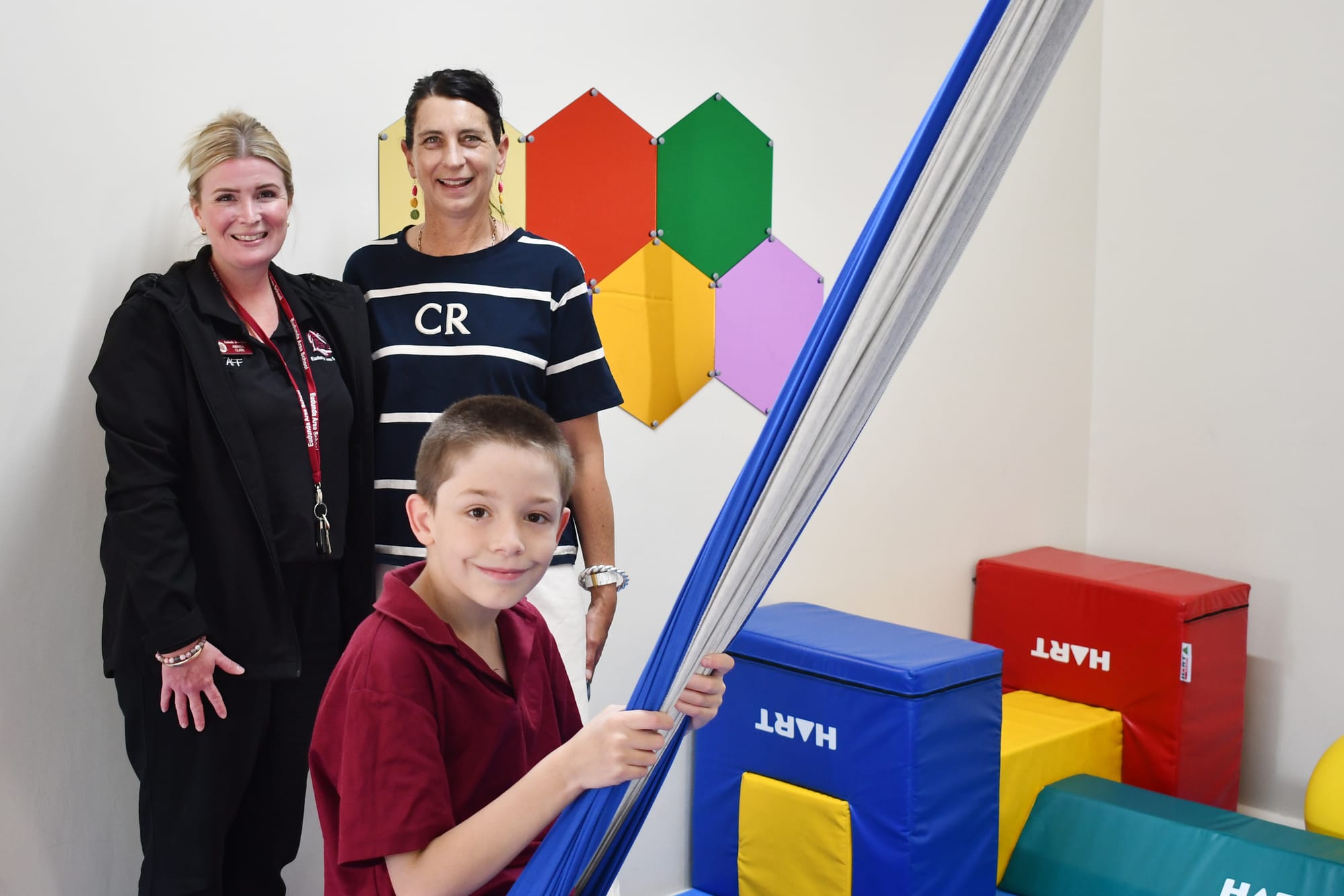 Amanda Clark (SSO) and Vanessa O'Brien (Autism Inclusion Teacher) watch on as Hunter Severin enjoys the Engine Room.